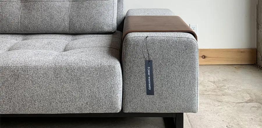 5 year warranty tag hanging on the arm of the soho sofa bed