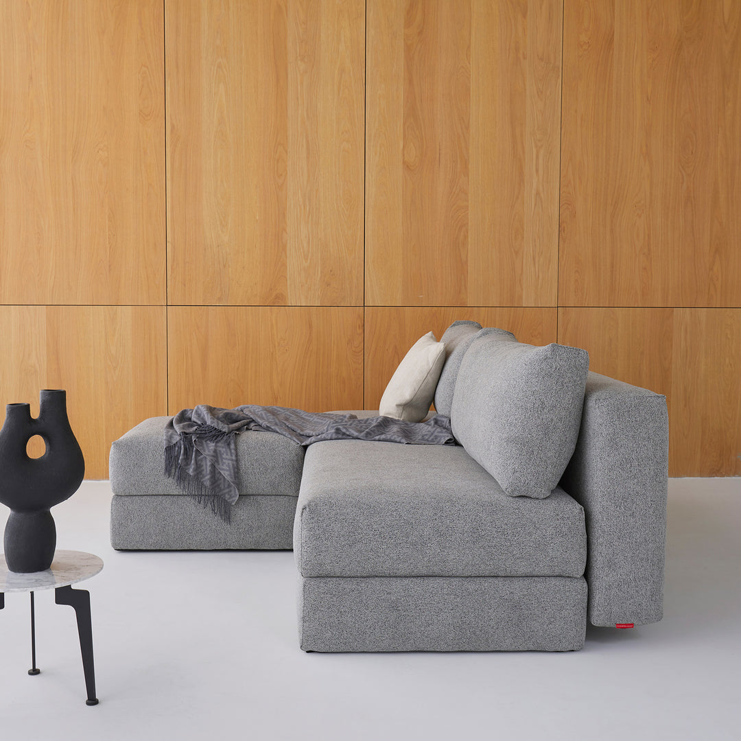 Arlmess nest storage sofa bed with matching ottoman in room with wood paneling