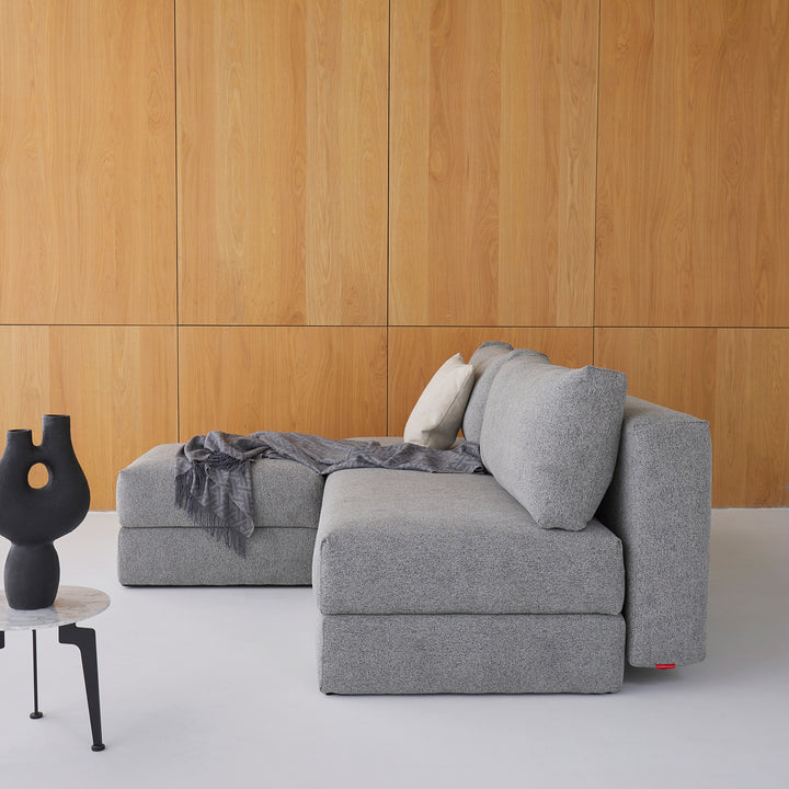 Arlmess nest storage sofa bed with matching ottoman in room with wood paneling